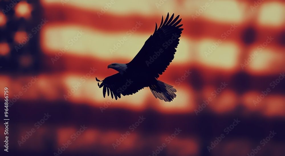 Fototapeta premium Majestic bald eagle soaring against a blurred American flag backdrop in a patriotic display