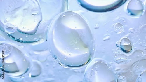 Blue foaming soap and bubbles of washing cleanser close up. Hyaluronic acid liquid makeup remover micellar water facial skin care. Powder foam close up background. Transparent cleaner. Shampoo texture