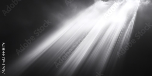 A close-up shot of a bright light shining through the clouds, casting a beam of light onto a dark background.