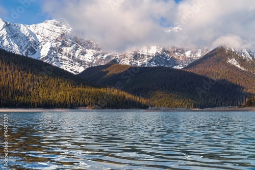 Cloudy Sky Over Sunlit Mountains And Lake photo
