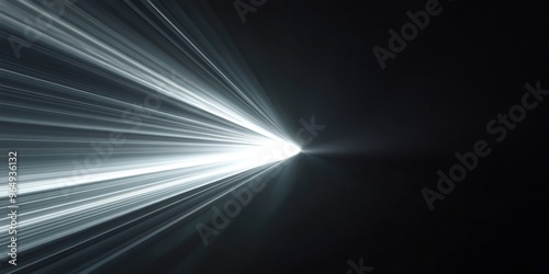 Abstract white light rays radiating from a central point on a black background. photo