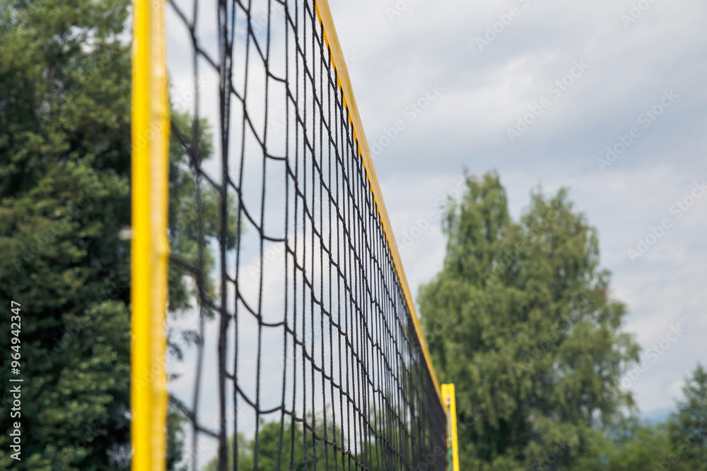 Volleyball net, outdoor scene with trees and sky in background, close-up view emphasizing sports equipment, sunny day concept Volleyball net, outdoor scene with trees and sky in background, close-up view emphasizing sports equipment, sunny day concept