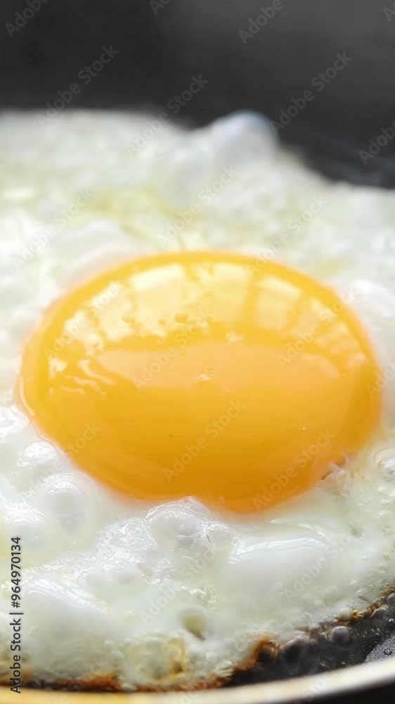 Cooking fried egg in frying pan. Close-up shot Cooking fried egg in frying pan. Close-up shot