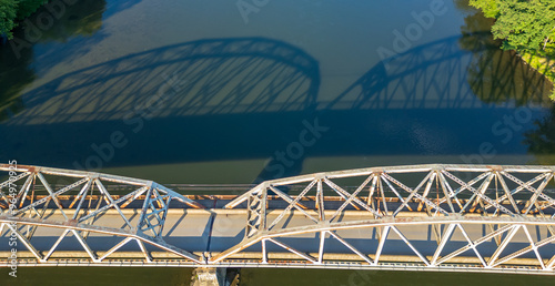 The reflection of the Tidioute Bridge on the Allegheny River as seen from above in Tidioute, Pennsylvania, USA on a sunny summer day