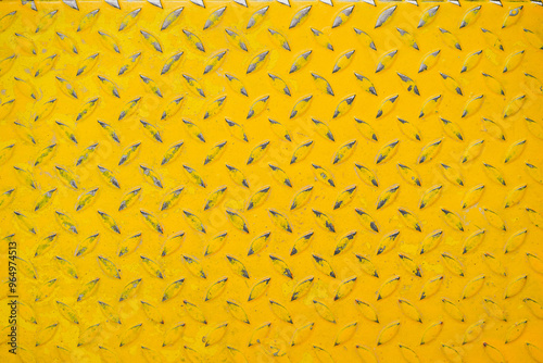 Yellow Floor. Top view of yellow painted metallic plate anti slip surface. Metal diamond plate texture. Closed up background pattern