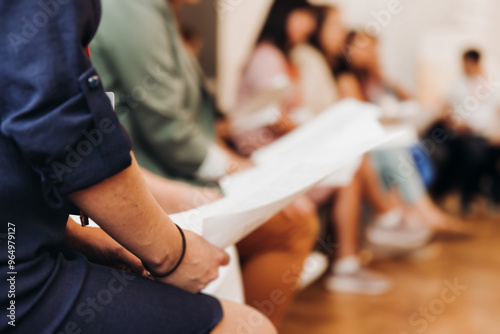Fotografía Choir rehearsal, vocal class singing in the auditorium hall, group of students o