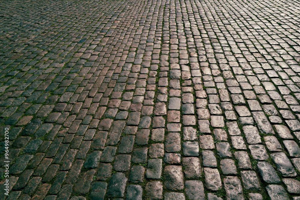 Stone road. Pavement texture. Stonework background for design. Granite cobblestoned pavement background. Abstract background of cobblestone pavement. Stone road. Pavement texture. Stonework background for design. Granite cobblestoned pavement background. Abstract background of cobblestone pavement.