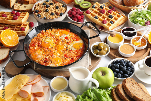 Different meals served for breakfast on white table