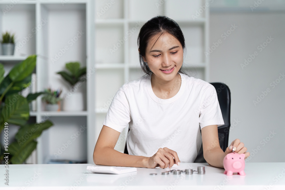 Young Woman Saving Money with Piggy Bank at Home Office - Financial Planning and Budgeting Concept