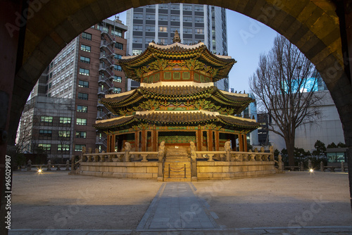 Jung-gu, Seoul, South Korea - December 18, 2020: Night view of Hwangudan Altar with the background of high rise buildings