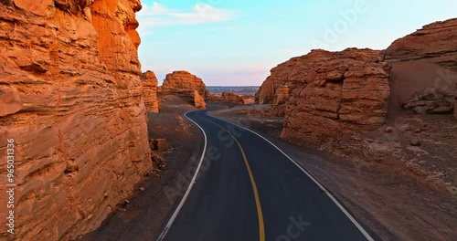 Aerial view of spectacular Yadan landform and road landscape at sunrise. The famous Dahaidao uninhabited area natural landscape in Xinjiang, China. photo