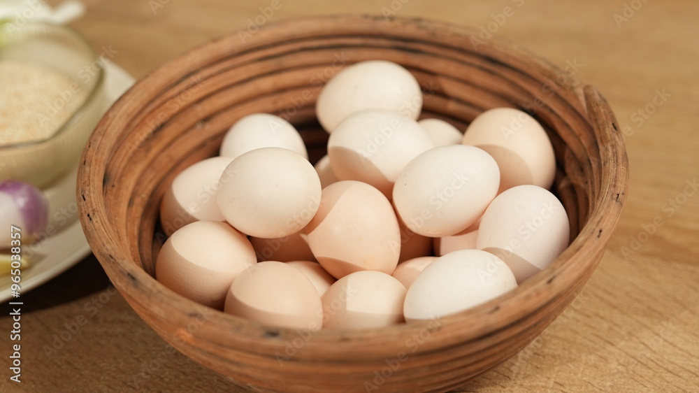 Basket of Chicken Eggs on Wooden Surface Basket of Chicken Eggs on Wooden Surface