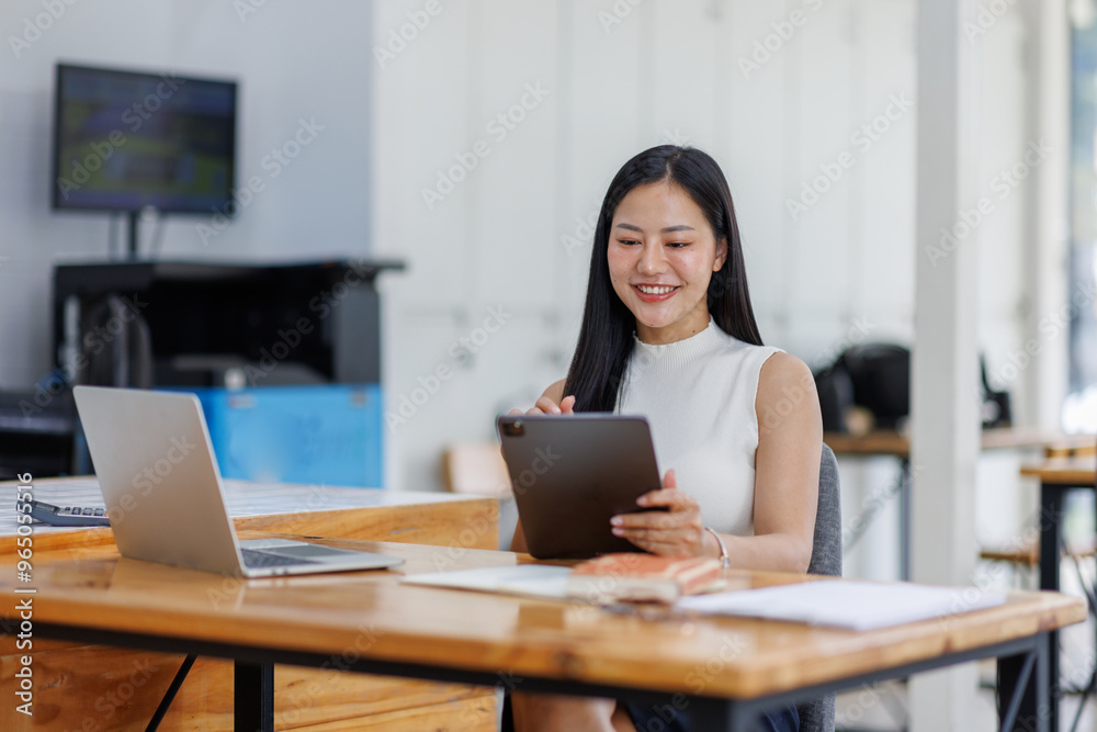 Business asian woman or female worker using a laptop computer to analyse her financial data.business people research or financial strategy in company concept. Laptop white screen mockup. Business asian woman or female worker using a laptop computer to analyse her financial data.business people research or financial strategy in company concept. Laptop white screen mockup.