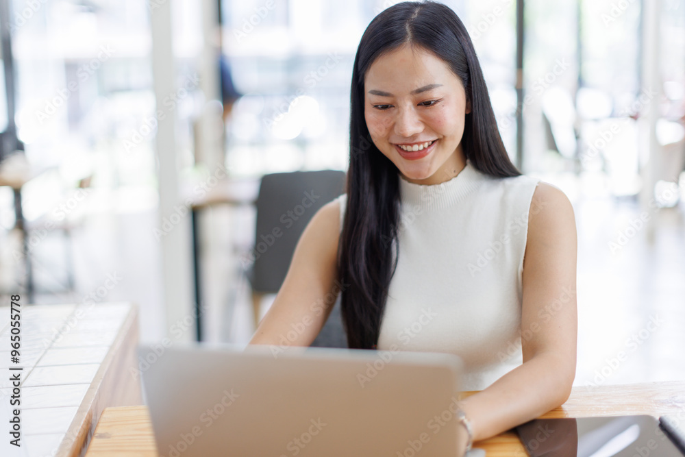 Business asian woman or female worker using a laptop computer to analyse her financial data.business people research or financial strategy in company concept. Laptop white screen mockup. Business asian woman or female worker using a laptop computer to analyse her financial data.business people research or financial strategy in company concept. Laptop white screen mockup.