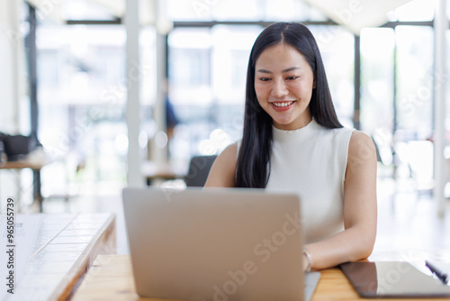 Business asian woman or female worker using a laptop computer to analyse her financial data.business people research or financial strategy in company concept. Laptop white screen mockup. Free Download Business asian woman or female worker using a laptop computer to analyse her financial data.business people research or financial strategy in company concept. Laptop white screen mockup. - GFXLoad