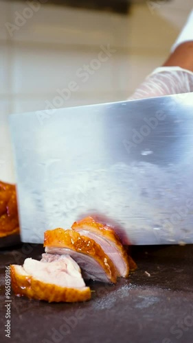 chef chopping roast duck close up