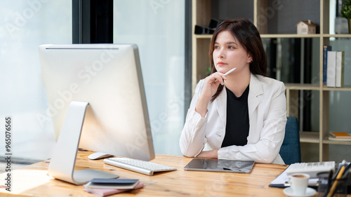 A thoughtful Caucasian businesswoman is gazing out the window, daydreaming or reflecting.