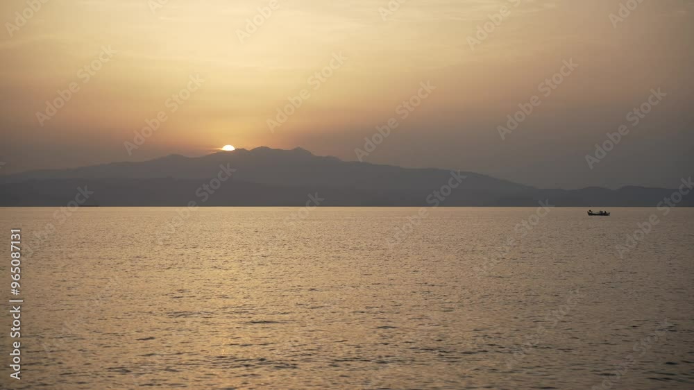 View of sun setting over mainland Greece from Skala Kallirachis, Skala Kallirachis, Thassos, Aegean Sea, Greek Islands, Greece, Europe View of sun setting over mainland Greece from Skala Kallirachis, Skala Kallirachis, Thassos, Aegean Sea, Greek Islands, Greece, Europe