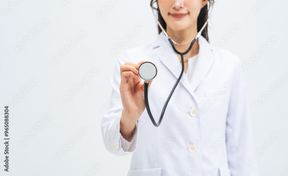 A female doctor auscultating with a stethoscope A female doctor auscultating with a stethoscope