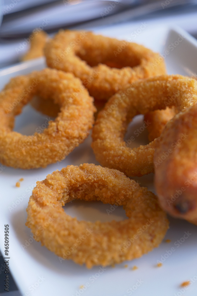 A plate full of Crispy and Golden Fried Onion Rings, perfect as an appetizer for any meal
