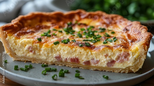 Close-up of a Savory Ham and Cheese Quiche Slice with Chives