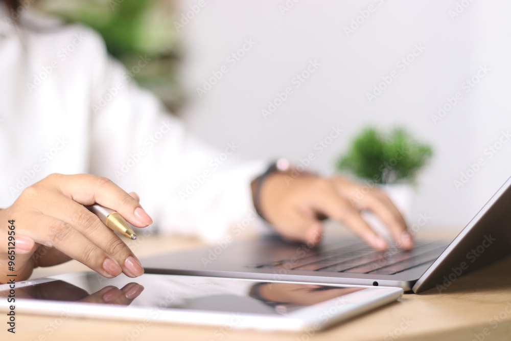Business woman working on laptop computer with digital tablet on office table. searching the information, freelance lifestyle. Female freelancer busy working on laptop, surfing the internet, Business woman working on laptop computer with digital tablet on office table. searching the information, freelance lifestyle. Female freelancer busy working on laptop, surfing the internet,
