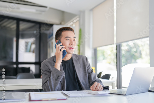 Asian Business man working with laptop. Young business man thinking Concentrated at work.