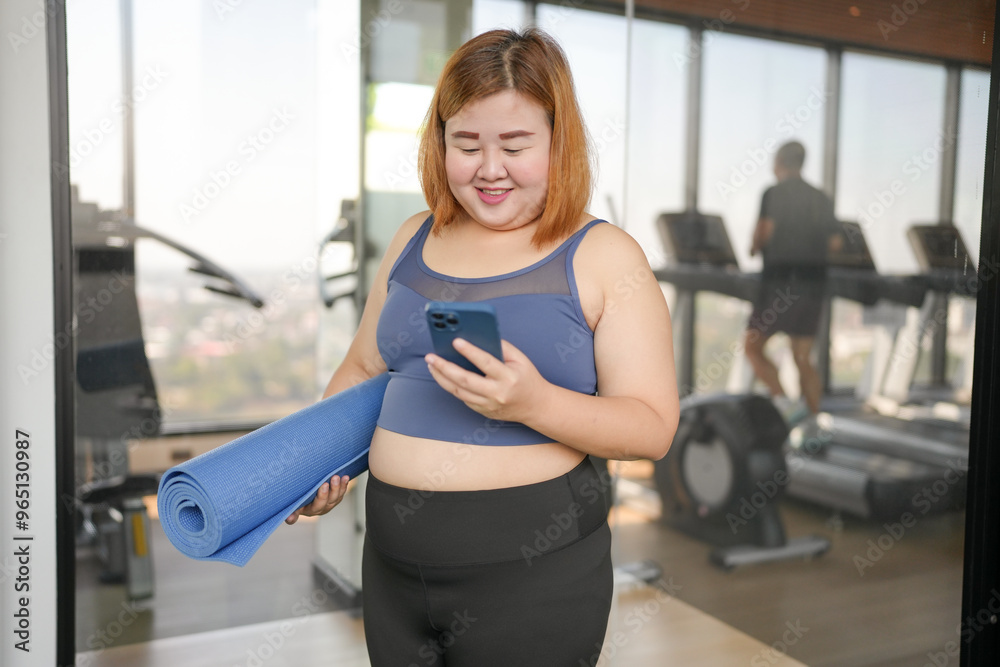Fototapeta premium Obese asian woman diet holding yoga mat for training yoga exercising fitness workout and health concept. training working out at gym