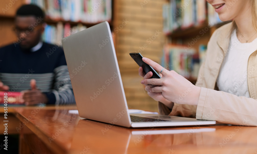 Phone, hands and woman with laptop in library at university for education, communication or online chat. Computer, smartphone and college student on mobile app for study schedule, research or project Phone, hands and woman with laptop in library at university for education, communication or online chat. Computer, smartphone and college student on mobile app for study schedule, research or project