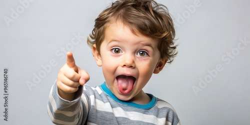 A sprightly smile and a pointed finger convey the whimsy and spontaneity of childhood, frozen in a charming