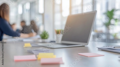 Professional desk with scattered office supplies, bathed in natural light, reflecting a creative work atmosphere.