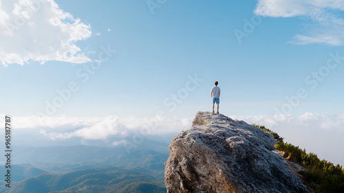 Person looking out at the horizon from a mountain peak, ready for new challenges