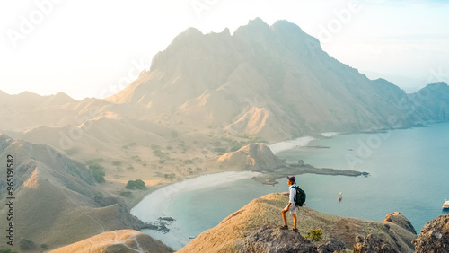 A young man enjoying the awesome view of Padar Island in Komodo National Park, Indonesia. summer background and summer holiday concept