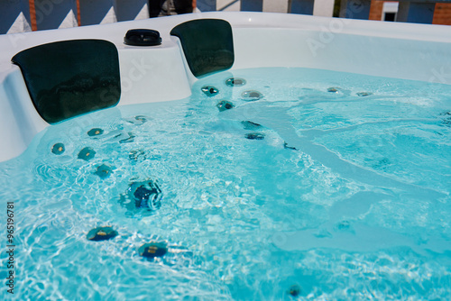 Close-up shot bubbling water in hot tub with headrests photo