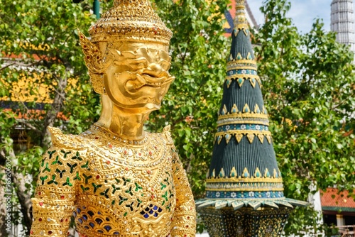 Bild auf Leinwand Asurapaksi, a gold giant-and-bird chimera statue beside a panom mak (banana leaf