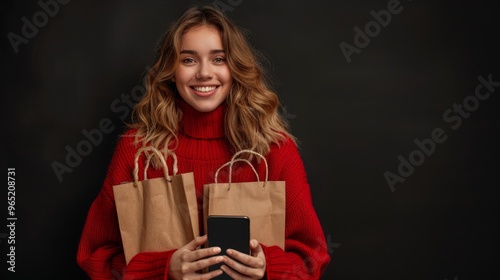 Black Friday shopping online, very happy women for purchases made holding shopper bags, comes out from screen smartphone. Sale deals and e-commerce. Isolated on black background with big cell phone  photo