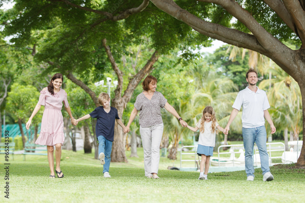 Caucasian family parent and their children picnic at the park in morning. Caucasian family parent and their children picnic at the park in morning.