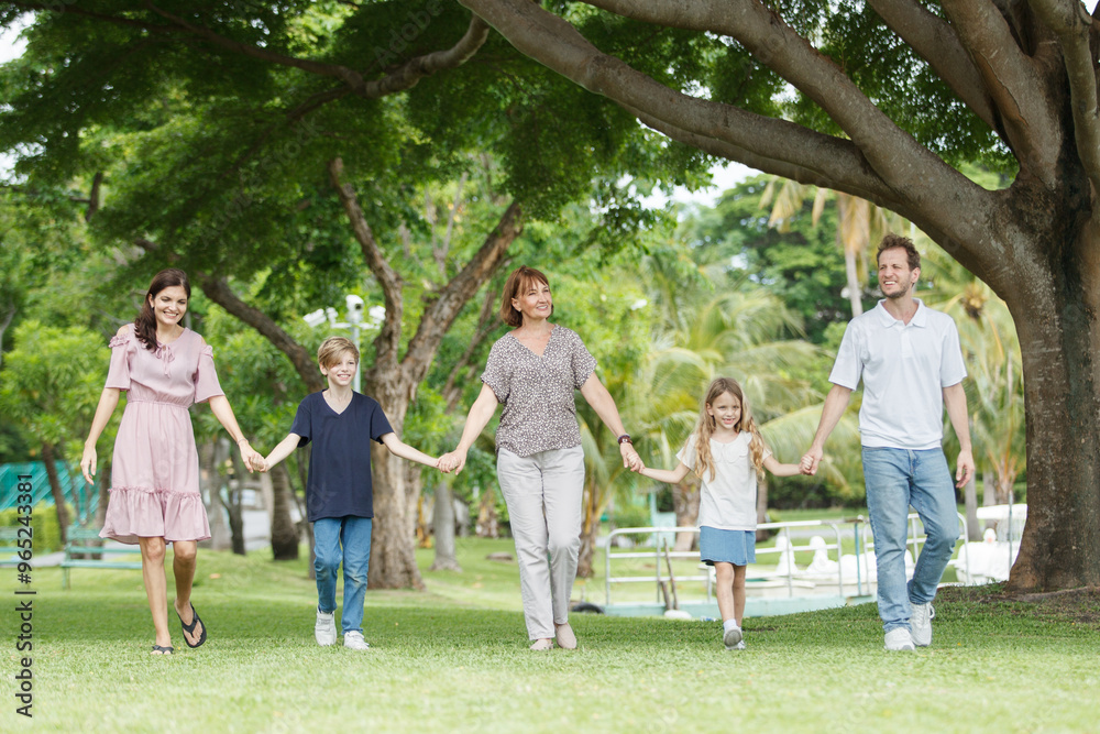 Obraz premium Caucasian family parent and their children picnic at the park in morning.