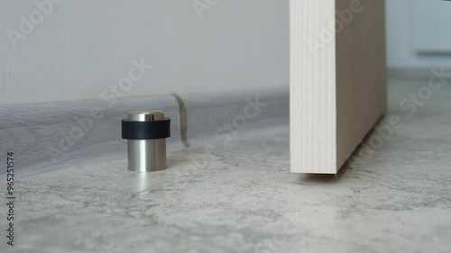 Close-up a stainless steel door stopper in a house or office. photo