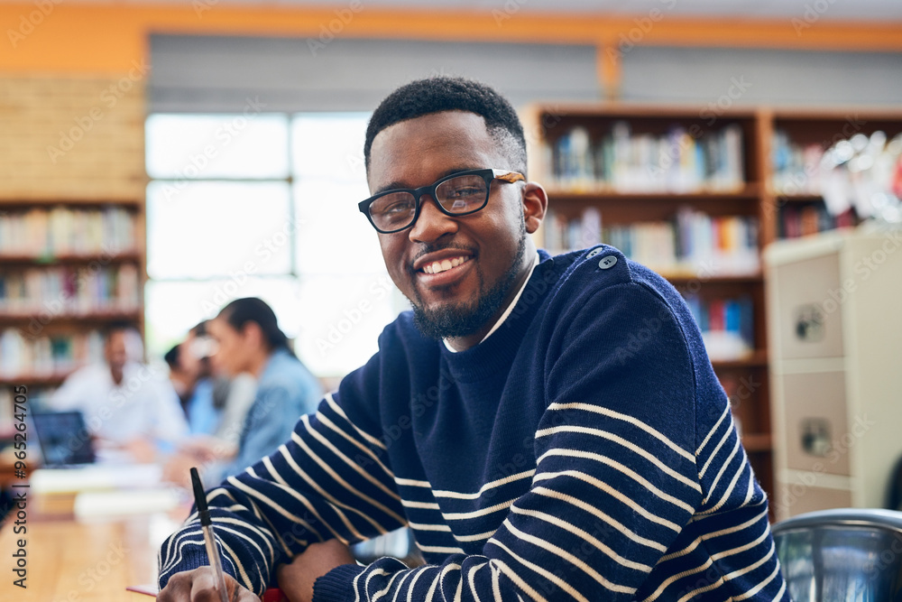 Obraz premium Black man, student and smile in portrait, library and writing notes for learning, development and research. Person, happy and pride with education, scholarship and studying at university in Nigeria