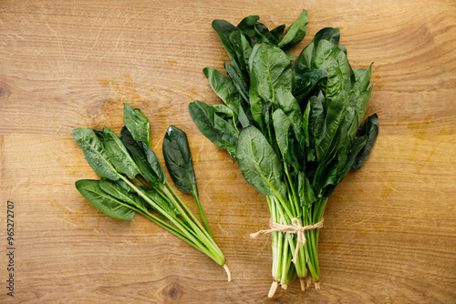 Fresh spinach on wooden background.