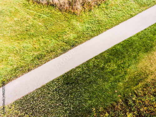 Aerial view of running path, jogging trail in the middle of park. Running training, no people. photo