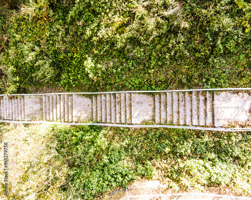 Aerial view of concrete stairs with fallen leaves in park. Running training, no people. photo