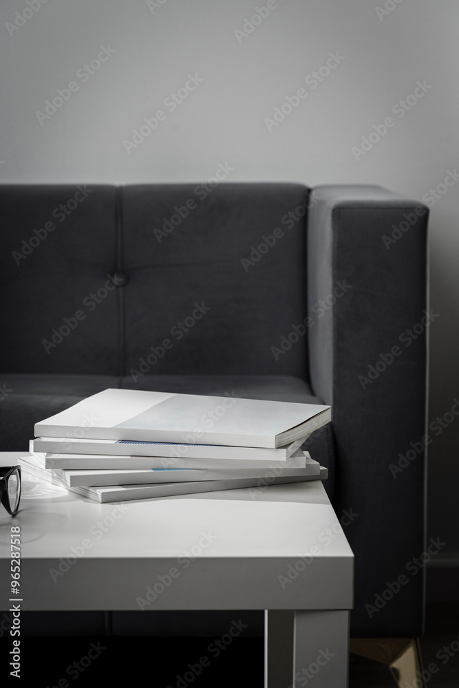 Stack of Magazines on White End Table in Living Room Stack of Magazines on White End Table in Living Room