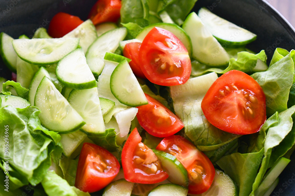 Vegetable salad with cucumber, lettuce and cherry tomatoes. Summer vegetables salad. Healthy and dietary food. Vegetable salad with cucumber, lettuce and cherry tomatoes. Summer vegetables salad. Healthy and dietary food.