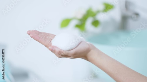 Wallpaper Mural A girl's hand filled with white foam was moving back and forth. Advertising scene for foaming products. The foam floats on the girl's hand, the blurred background is green leaves Torontodigital.ca