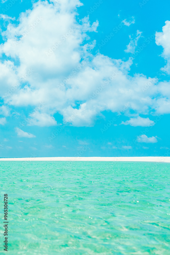 Beautiful white sandy beach with turquoise ocean water and blue sky. Summer vacation and summer holiday concept. Beautiful white sandy beach with turquoise ocean water and blue sky. Summer vacation and summer holiday concept.