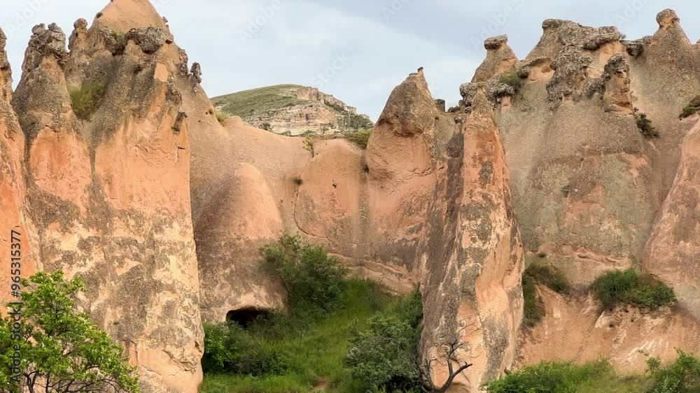 The picturesque Zelve Valley in cloudy weather in Turkey. Unusual rock formations that tell ancient stories about Cappadocia. Rocks that once had houses carved by ancient inhabitants. 4K The picturesque Zelve Valley in cloudy weather in Turkey. Unusual rock formations that tell ancient stories about Cappadocia. Rocks that once had houses carved by ancient inhabitants. 4K