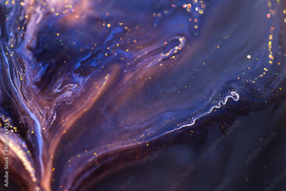 Colorful liquid paint abstract background. Blue, purple and black acrylic paints with shining golden glitter
