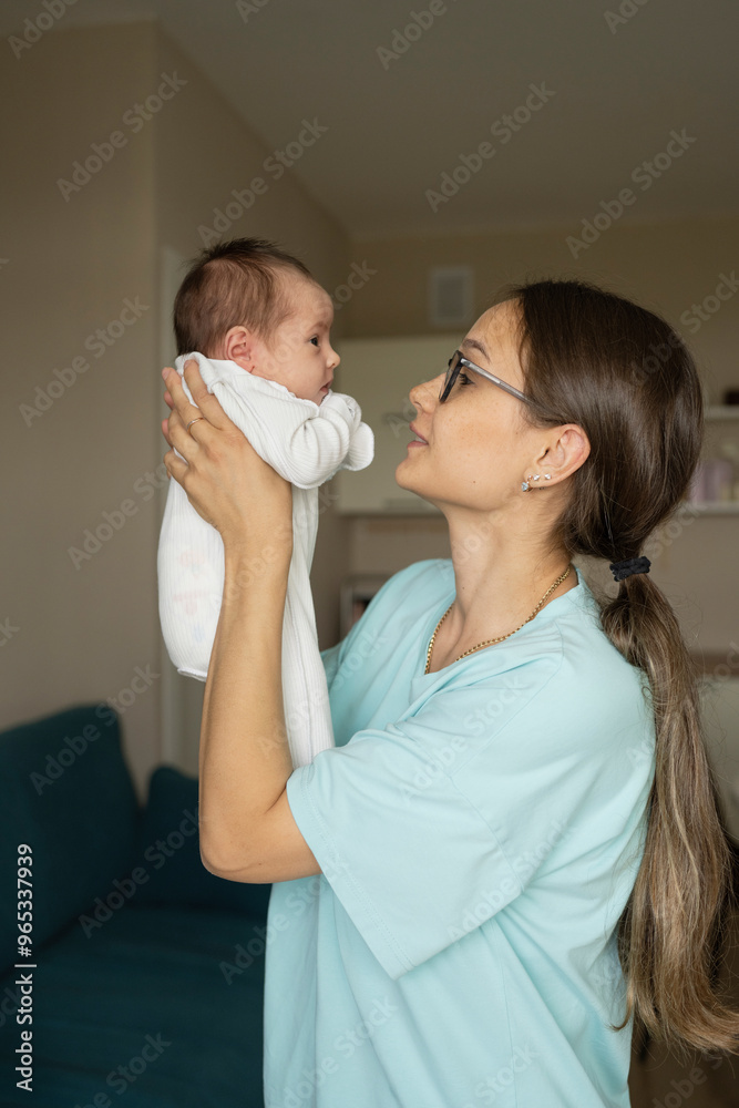 Mother lifting new born baby at home Mother lifting new born baby at home